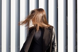 Young brunette woman with long, straight, shiny hair